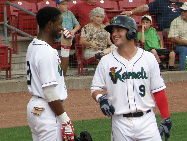 Tyler Grimes (9) shares a light moment in the on deck circle with Kernels team mate Niko Goodrum