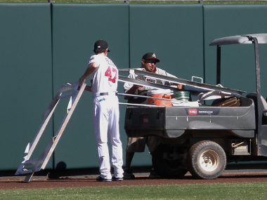 Jake Reed gives a helping hand to a grounds crew member who took a corner a bit sharp