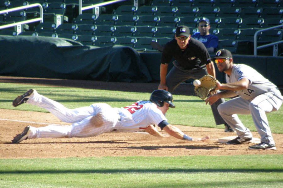 Max Kepler diving back in to first base on an attempted pick off