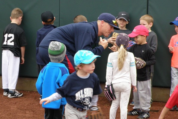 Cam Booser gets a "pinky promise" from a young camper