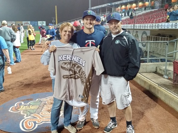 Brett Doe and his parents show off his "Jurassic" jersey from a recent Kernels charity night