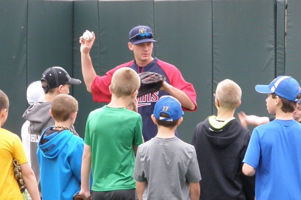 Zach Tillery with instructions for campers on proper grip and form