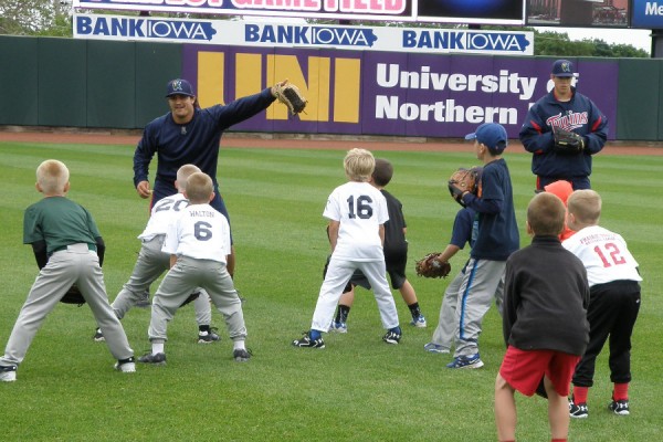 TJ White and Trevor Hildenberger working with a group of outfielders