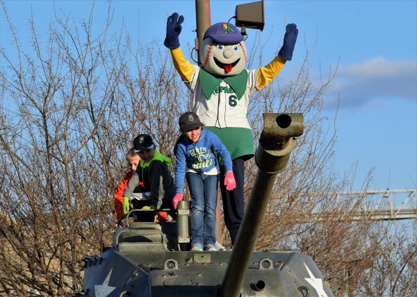 Mr Shucks spends some time with young Kernels fans while they wait for the team's bus to arrive.